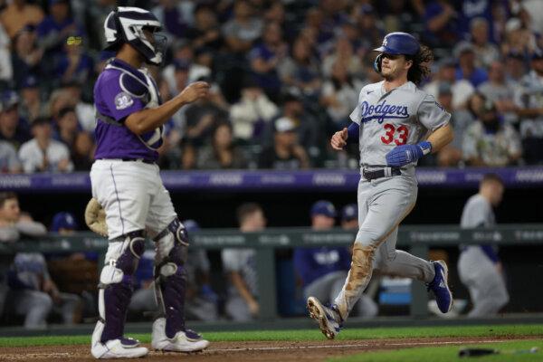 James Outman (33) of the Los Angeles Dodgers scores on a Kolten Wong RBI single against the Colorado Rockies in the fifth inning during Game Two of a Doubleheader at Coors Field in Denver on Sept. 26, 2023. (Matthew Stockman/Getty Images)