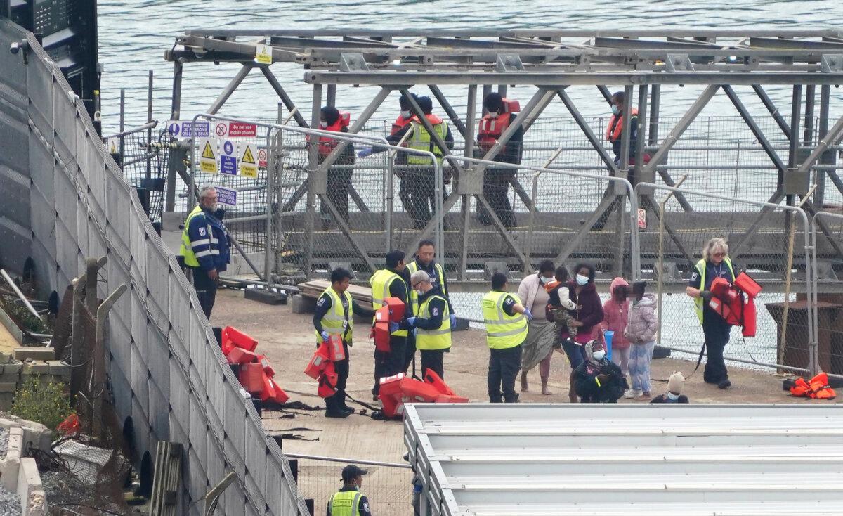 A group of people thought to be migrants, including young children, are brought into Dover, Kent, on Sept. 26, 2023. (Gareth Fuller/PA)