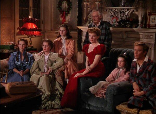 (L–R) The Smith family: Rose (Lucille Bremer), Mother Anna (Mary Astor), Agnes (Joan Carroll), Esther (Judy Garland), grandfather (Harry Davenport), Tootie (Margaret O’Brien), and Lon (Henry H. Daniels Jr.), in “Meet Me in St. Louis.” (Warner Bros.)