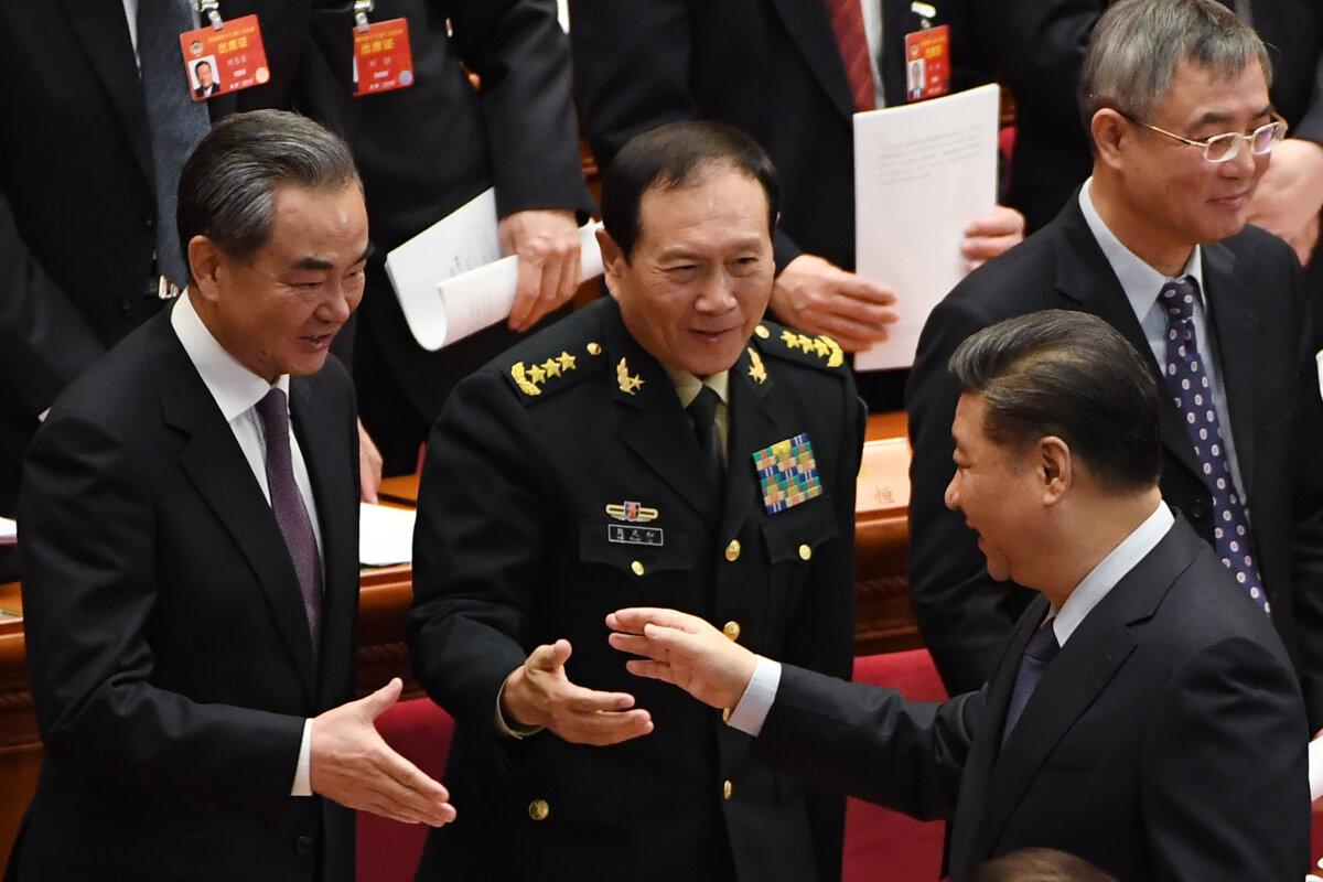 China's leader Xi Jinping (R) shakes hands with Foreign Minister Wang Yi (L) and Defence Minister Wei Fenghe as they leave after the closing session of the Chinese People's Political Consultative Conference at the Great Hall of the People in Beijing on March 13, 2019. (Greg Baker /AFP via Getty Images)