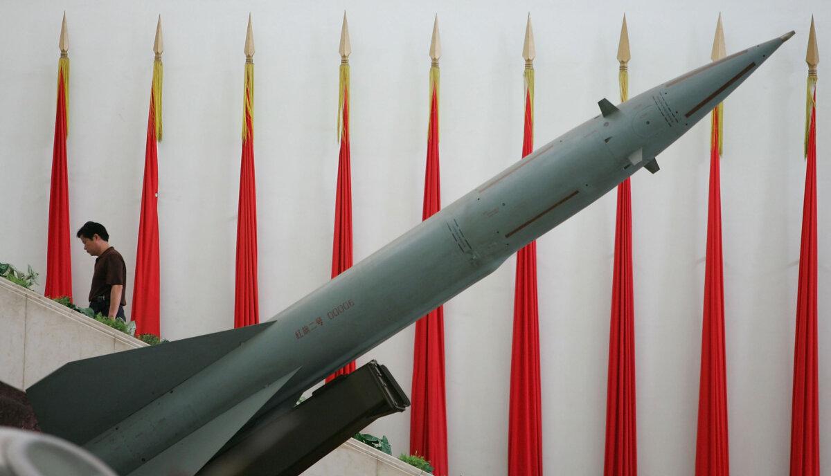 A Chinese man walks past a China-made missile at the Military Museum in Beijing, on Sept. 6, 2005. (Guang Niu/Getty Images)