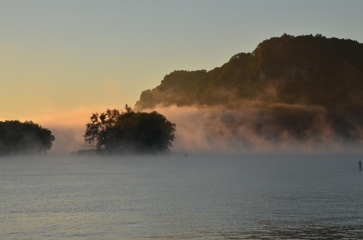 The rising sun drives the morning mists from the river. (Kevin Revolinski)