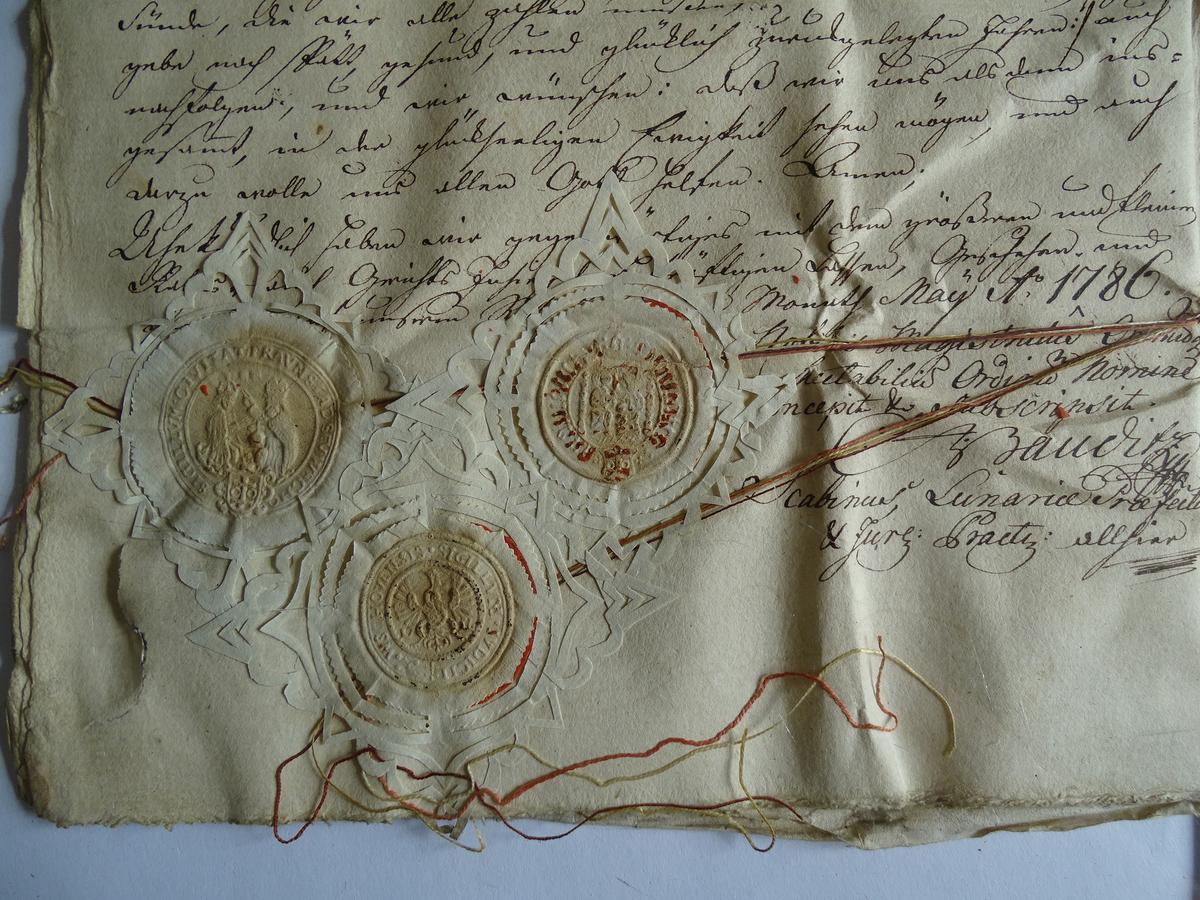 Wafer seals on documents dating from 1786 were found inside a parcel that was encased within the copper orb. (Courtesy of Marcin Pechacz)