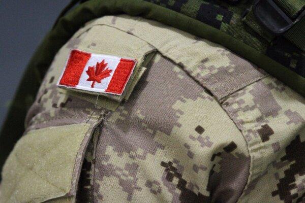 A Canadian flag patch is shown on an Armed Forces member's uniform in Trenton, Ont., on October 16, 2014. (The Canadian Press/Lars Hagberg)