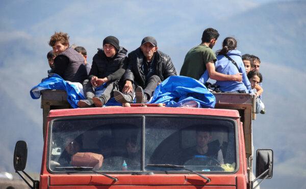 Refugees from Nagorno-Karabakh upon their arrival at the border village of Kornidzor, Armenia, on Sept. 27, 2023. (Irakli Gedenidze/Reuters)