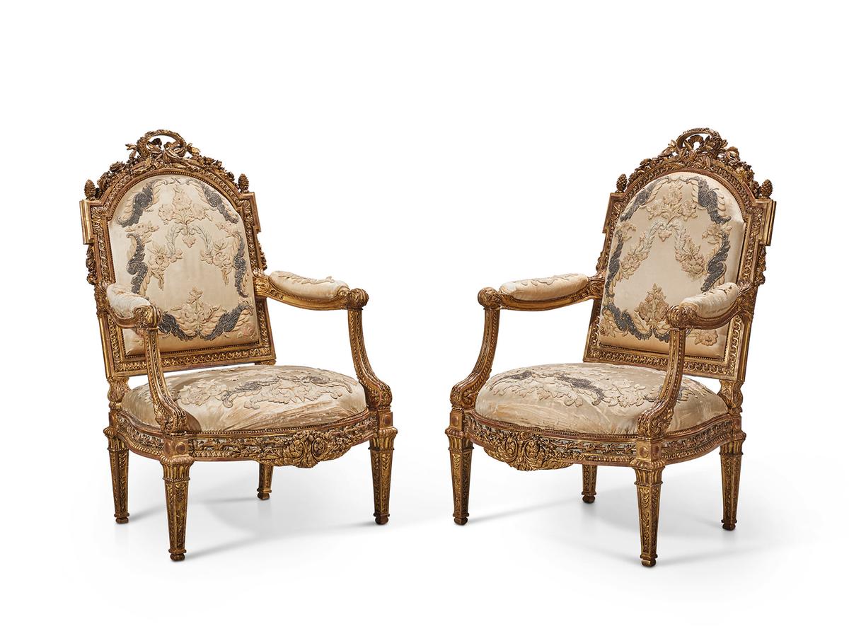 "A Pair of Late Louis XV Giltwood and White-Painted Fauteuils," circa 1770–1771, by Louis Delanois, Joseph-Nicolas Guichard, and Jean-Baptiste Cagny for Madame du Barry’s Chateau de Louveciennes. (Christie’s Images Limited 2023)