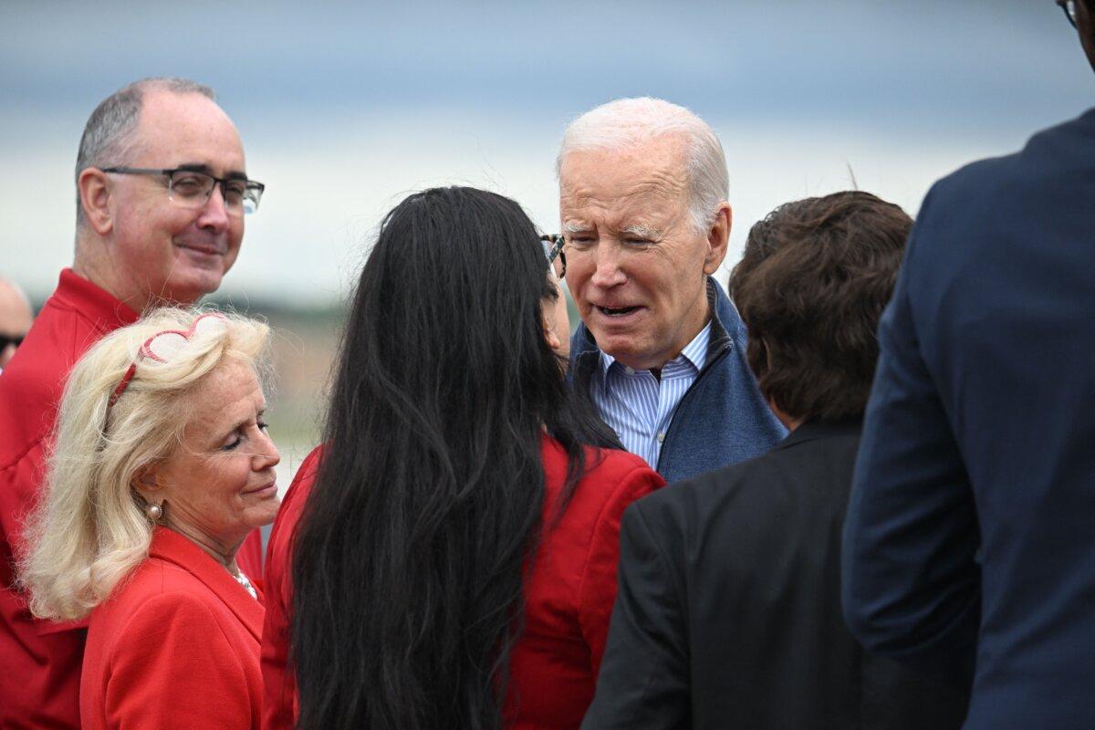 President Joe Biden (C) is welcomed by United Auto Workers (UAW) President Shawn Fain (L) and Rep. Debbie Dingell (D-Mich.) (2nd L) on arrival at Detroit Metropolitan Wayne County Airport in Romulus, Mich., on Sept. 26, 2023. (Jim Watson/AFP via Getty Images)