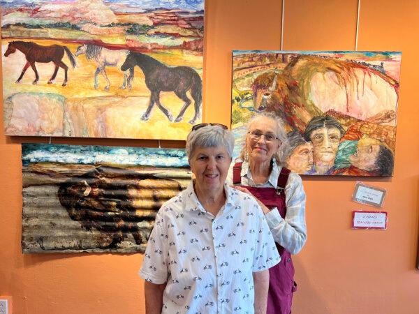 Local artists Meredith Britt (L) and Dale Tozzi are two of the artists of El Zocalo Cooperative Art Gallery on Plaza Park in Las Vegas, New Mexico. Behind them is some of Tozzi’s work. (Mary Ann Anderson/TNS)