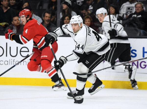 Nate Thompson (44) of the Los Angeles Kings makes a breakout pass during the game against the Carolina Hurricanes at Staples Center in Los Angeles on Dec. 2, 2018. (Harry How/Getty Images)