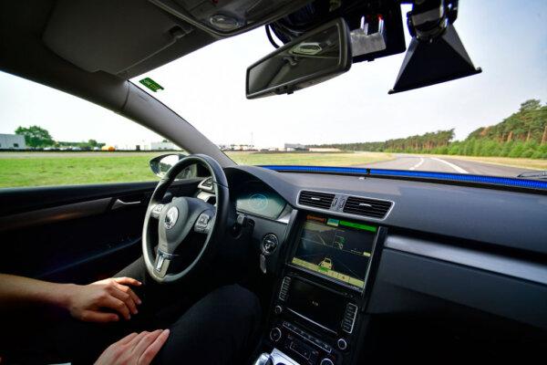 A driver presents a Cruising Chauffeur, a hands free self-driving system designed for motorways during a media event by Continental to showcase new automotive technologies in Hannover, Germany, on June 20, 2017. (Alexander Koerner/Getty Images)