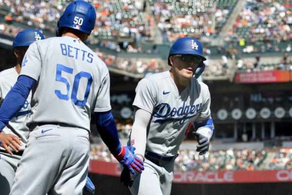 Enrique Hernandez (8) of the Los Angeles Dodgers high-fives Mookie Betts (50) after hitting a home run against the San Francisco Giants in the fifth inning at Oracle Park in San Francisco on Oct. 1, 2023. (Brandon Vallance/Getty Images)