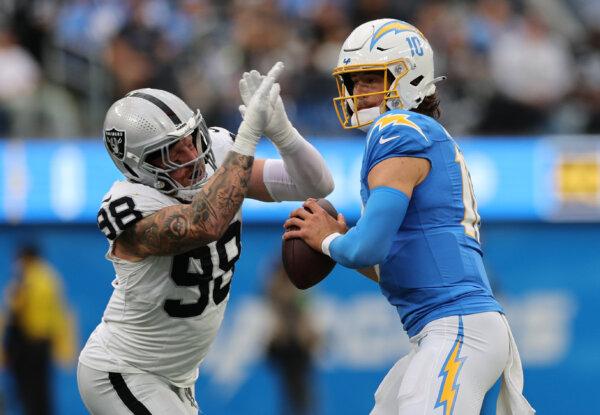 Justin Herbert (10) of the Los Angeles Chargers looks to pass against the Las Vegas Raiders during the first half at SoFi Stadium in Inglewood, Calif., on Oct. 1, 2023. (Kevork Djansezian/Getty Images)