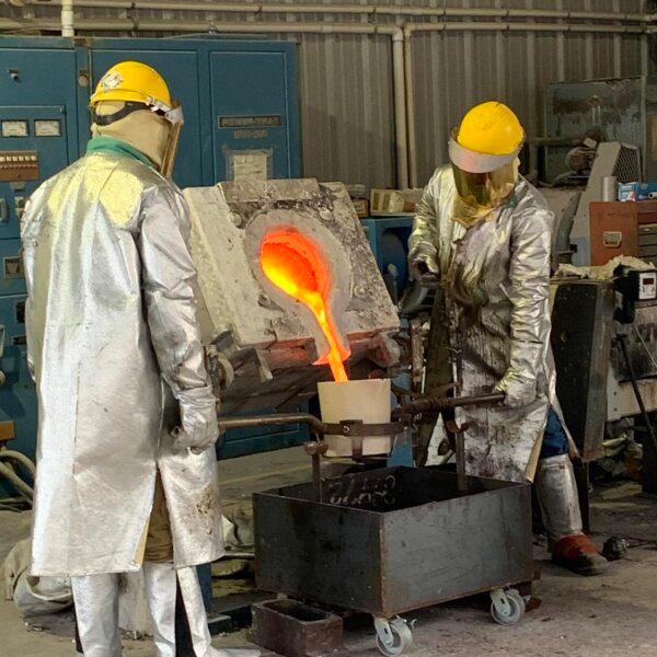 The casting stage requires skilled workers at the Pyrology Foundry in Bastrop, Texas, to place bronze ingots inside a graphite crucible heated to approximately 2000 degrees in a furnace. (Claire Suminski)