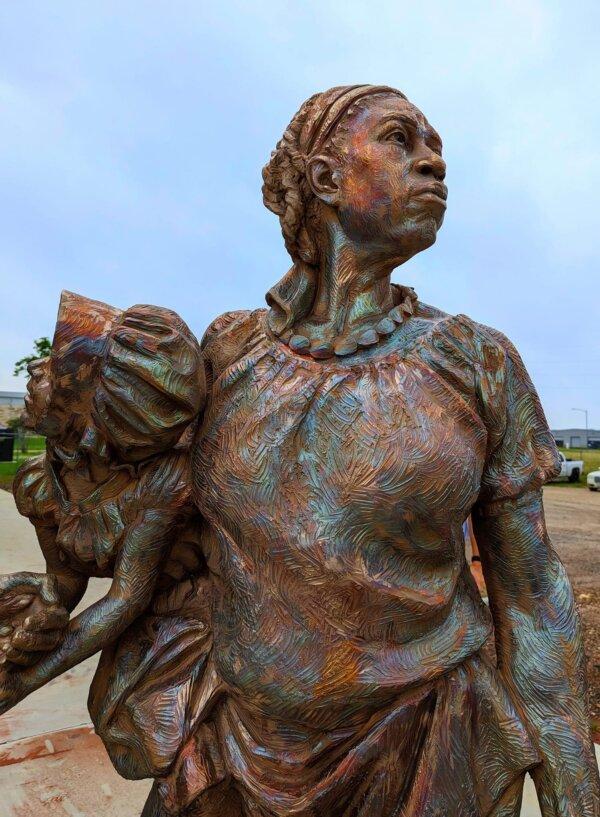 Once the sculpture is cast and cooled, a torch is used to heat the surface and chemicals are applied. The resulting chemical reaction leaves a distinct patina, as evidenced on figure representing Salley, an enslaved woman. (Claire Suminski)