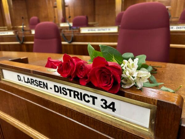 Roses rest on the Senate desk of late North Dakota Republican state Sen. Doug Larsen, at the state Capitol in Bismarck, N.D., Oct. 2, 2023. (AP Photo/Jack Dura)