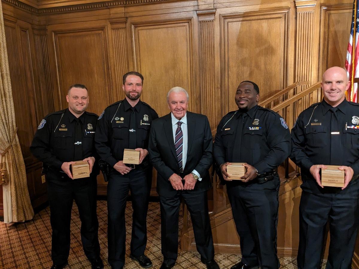 (Left to right): Officer Sage-Thomas Wiggins, Officer Kevin DeFrain, Police Commissioner William Dwyer, Officer David Chapman, and Officer Daniel Rose. Officers are holding the boxes for the engraved Shinola Watch received as part of their Medal of Valor Award. (Courtesy of City of Warren Police Department)