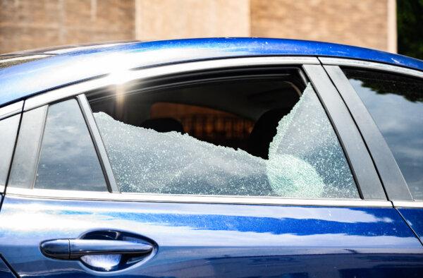 A car with a window smashed in Los Angeles, Calif., on May 16, 2023. (John Fredricks/The Epoch Times)