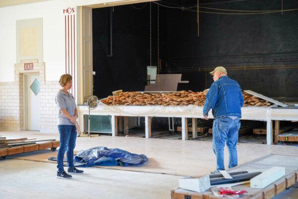 Alison Miller and Bob Clouse talk in front of a performance stage at the future Old School Community Center in Otisville, N.Y., on Oct. 4, 2023. (Cara Ding/The Epoch Times)