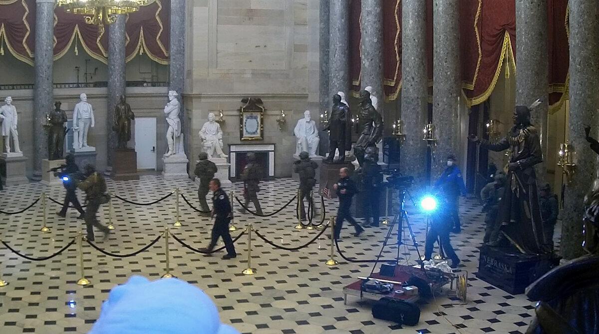 Tactical teams move from the Small House Rotunda into Statuary Hall to clear any remaining protesters at 2:59 p.m. on Jan. 6, 2021. (U.S. Capitol Police/Screenshot via The Epoch Times)