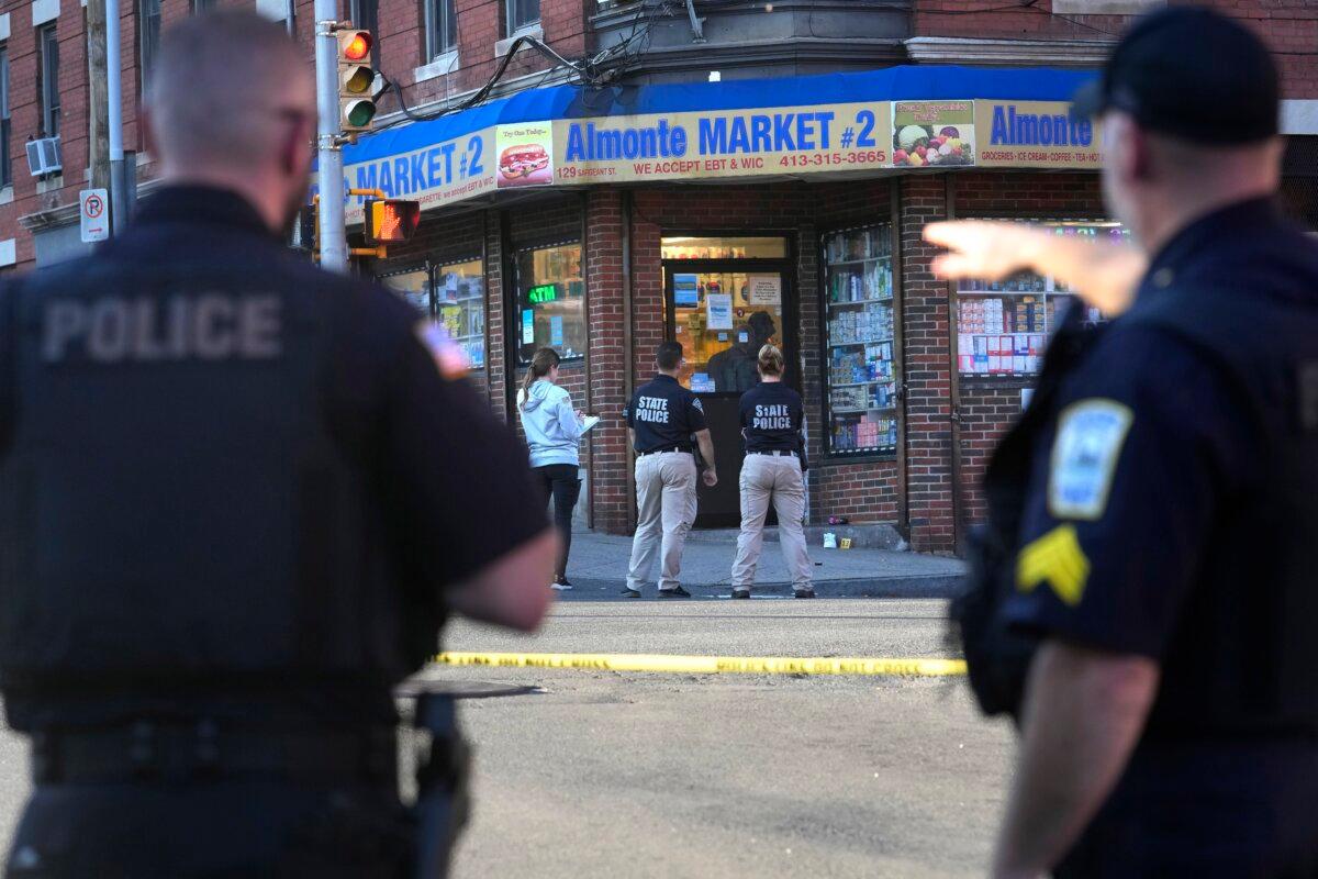 Law enforcement officials investigate the scene where multiple were shot, in Holyoke, Mass., on Oct. 4, 2023. (Steven Senne/AP Photo)