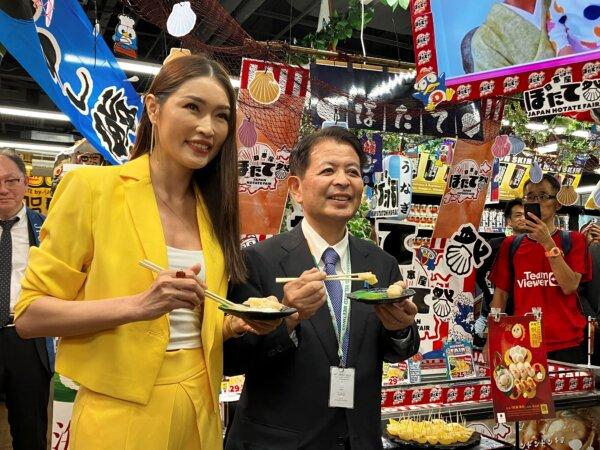 Japanese Agriculture Minister Ichiro Miyashita (R), and Malaysian celebrity Amber Chia attend an event at Japanese store, Don Don Donki in Kuala Lumpur, Malaysia to promote the safety and deliciousness of Japanese scallops to shoppers on Oct. 4, 2023. (Eileen Ng/AP Photo)