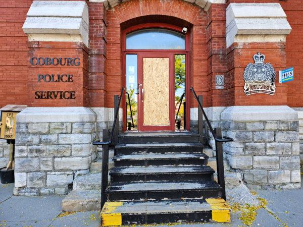 Cobourg Police Service headquarters is seen with a boarded-up door on Oct. 2, 2023. (Tara MacIsaac/The Epoch Times)