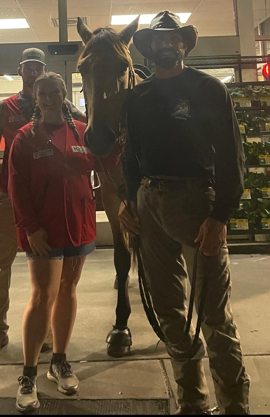Maci Aytes (L) poses with Matt Perella (R) and Buck in front of Tractor Supply in Sumter, N.C., on Sept. 28, 2023. (Courtesy of Jim Lowder)