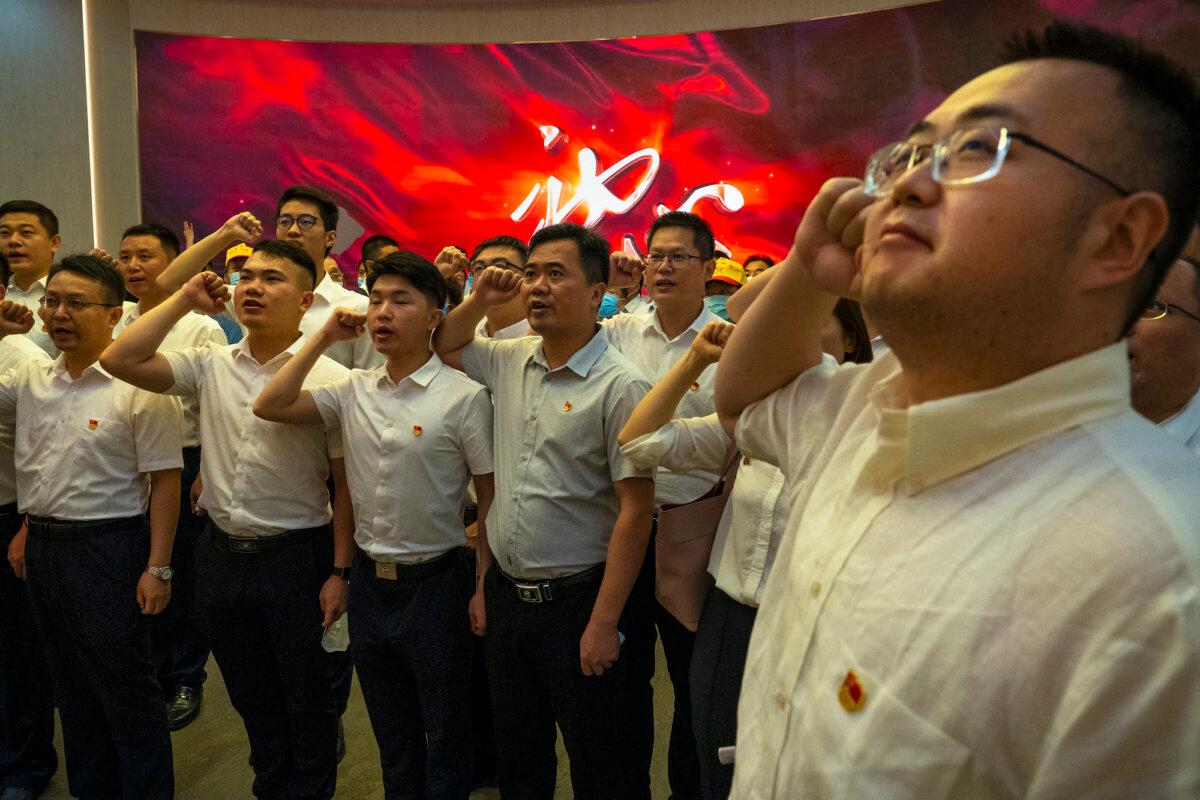Visitors take an oath inside of the Memorial of the First National Congress of the Communist Party of China, in Shanghai, China, on June 17, 2021. (Andrea Verdelli/Getty Images)