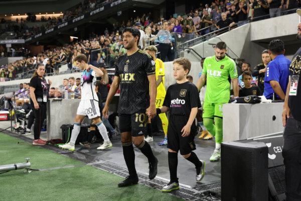 Los Angeles FC captain Carlos Vela (10) and goalkeeper Maxime Crepeau (16) lead the team to the field at the opening ceremonies against the Minnesota United at BMO Stadium in Los Angeles, on Oct 4, 2023. (Courtesy of Los Angeles FC via The Epoch Times)