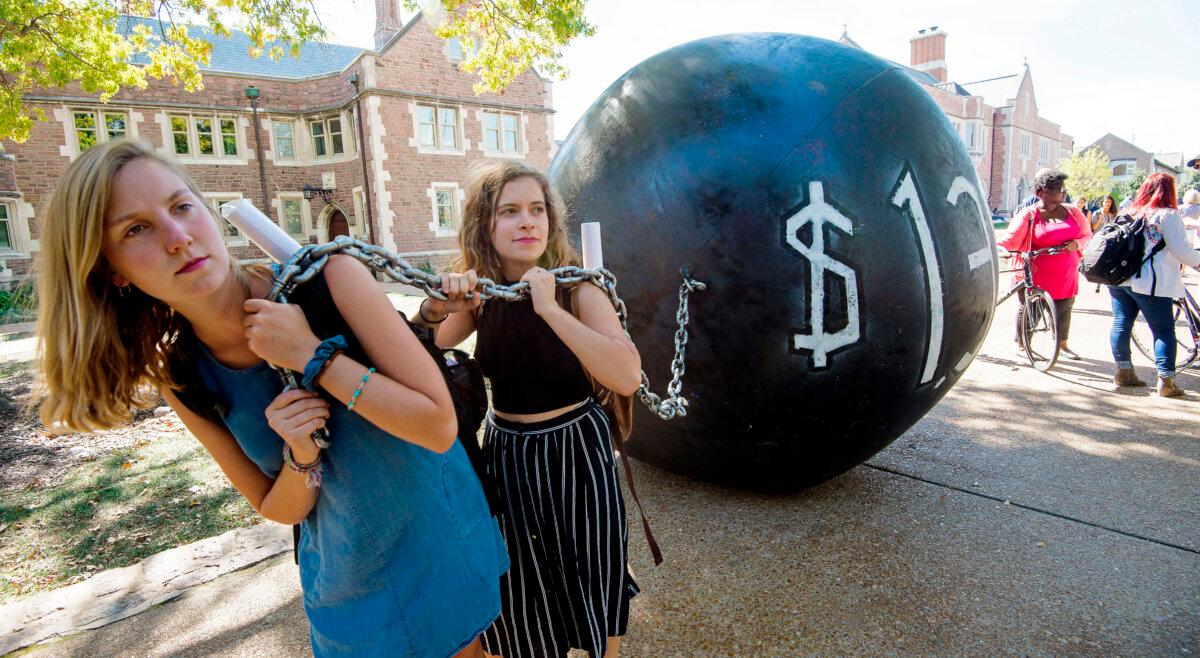 Students participate in a demonstration where they pull a mock “ball & chain,” which represents the then-$1.4 trillion student debt, at Washington University in St. Louis, Mo., Oct. 9, 2016. (Paul J. Richards/AFP via Getty Images)