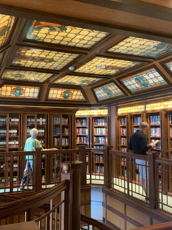 Passengers browse for books in the elegant ship library on the Cunard Queen Victoria. Photo courtesy of Sharon Whitley Larsen.