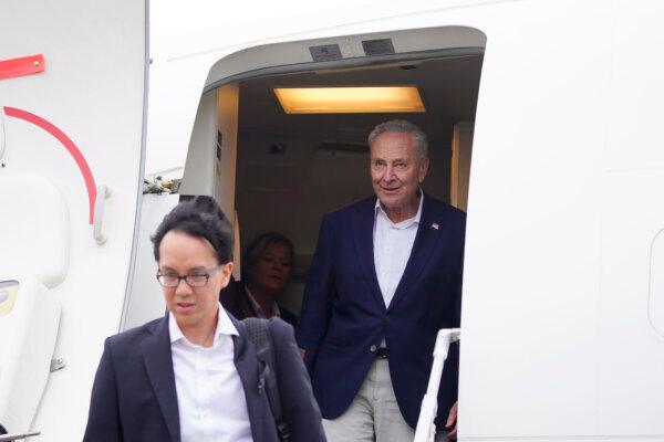 U.S. Senate Majority Leader Chuck Schumer, (D-N.Y.) (R) and other members of the delegation arrive at Shanghai Pudong International Airport in Shanghai on Oct. 7, 2023. (Aly Song/Pool Photo via AP)