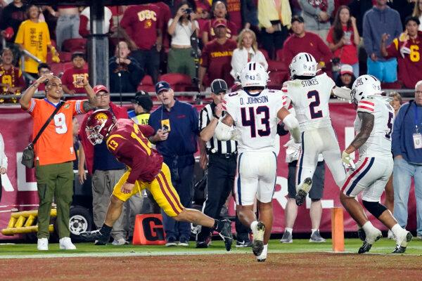 Southern California quarterback Caleb Williams (13) scores a two-point conversion to give Southern California the lead during overtime of an NCAA college football game against Arizona in Los Angeles on Oct. 7, 2023. (Marcio Jose Sanchez/AP Photo)