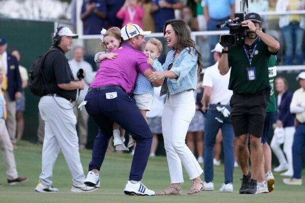 Luke List of the United States celebrates with wife Chloe, daughter Ryann and son Harrison after winning the Sanderson Farms Championship at The Country Club of Jackson in Jackson, Miss., on Oct. 8, 2023. (Raj Mehta/Getty Images)