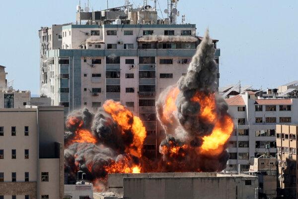 A ball of fire erupts from the Jala Tower as it is destroyed in an Israeli airstrike on Hamas targets in Gaza City, which is controlled by the Hamas terrorist group, on May 15, 2021. (Mahmud Hams/AFP via Getty Images)