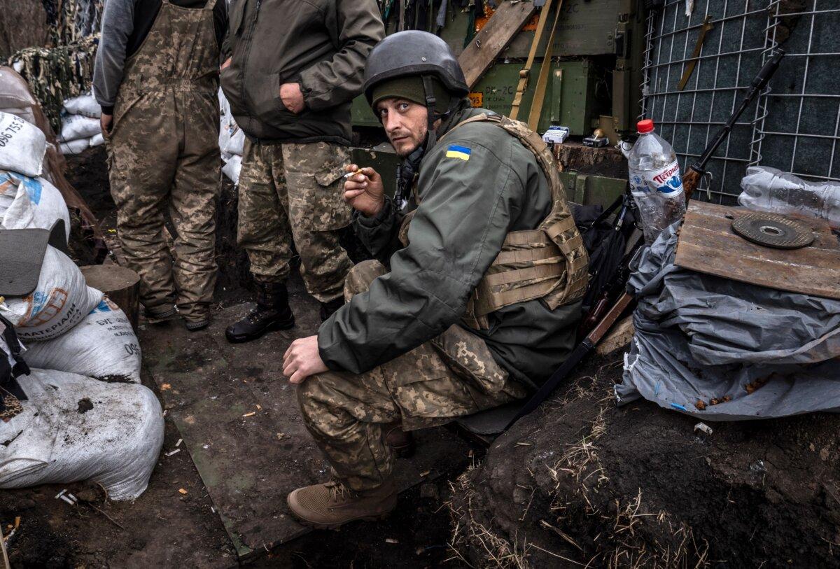 A Ukrainian serviceman smokes a cigarette in a trench on the front line east of Kharkiv, on March 31, 2022. (Fadel Senna/AFP via Getty Images)