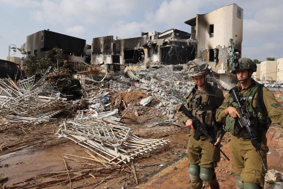 Soldiers walk in front of an Israeli police station that was damaged during battles to dislodge Hamas terrorists on Oct. 8, 2023. (Jack Guez/AFP via Getty Images)