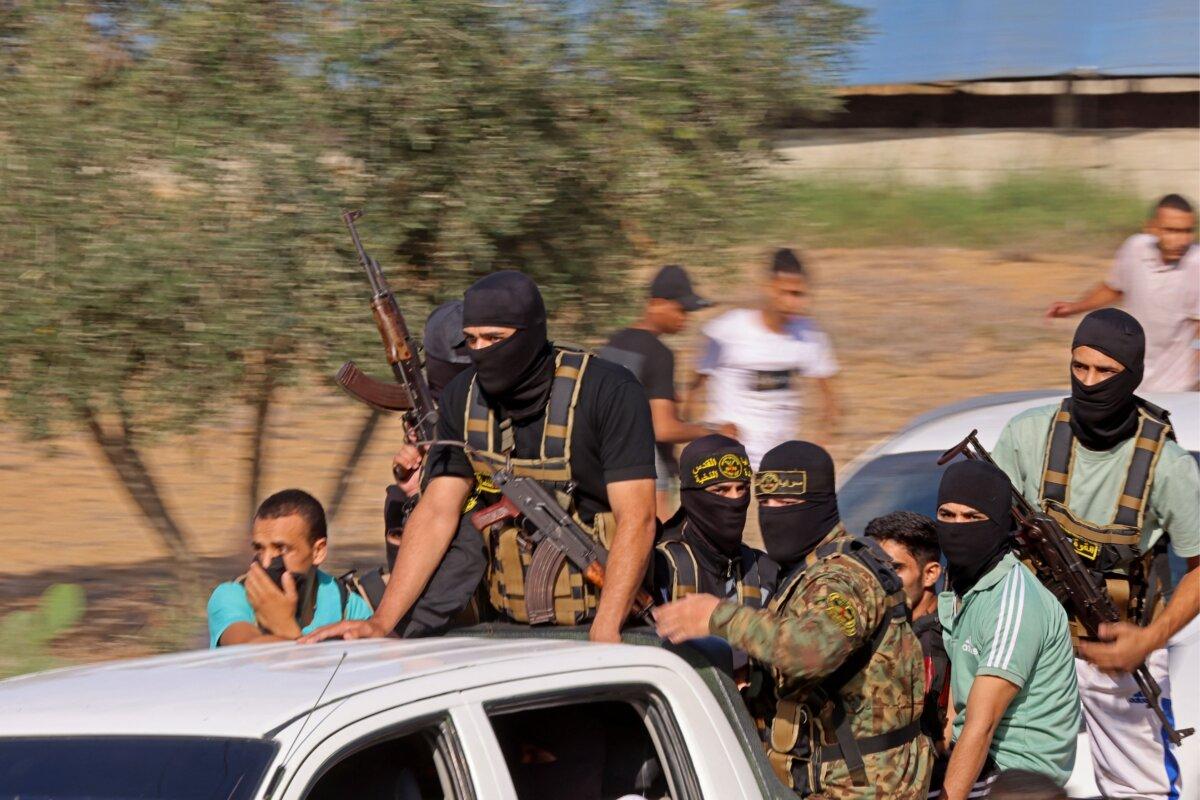 Hamas terrorists move toward the border fence with Israel from Khan Yunis in the southern Gaza Strip on Oct. 7, 2023. (Said Khatib/AFP via Getty Images)