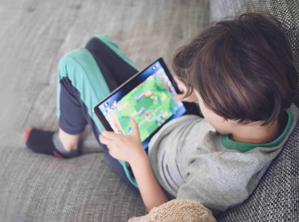 A young boy playing an addictive online game. (Illustration - ozrimoz/Shutterstock)