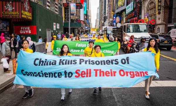 Falun Gong practitioners participate in a parade marking the 30th anniversary of Falun Gong's introduction to the public, in New York on May 13, 2022. (Samira Bouaou/The Epoch Times)