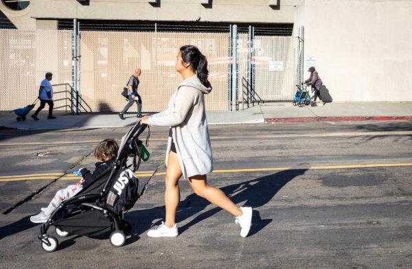 People walk down a street in San Diego, Calif., on Oct. 4, 2023. (John Fredricks/The Epoch Times)