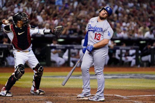 Los Angeles Dodgers' Max Muncy (13) reacts after a foul tip was caught by Arizona Diamondbacks catcher Gabriel Moreno, left, during the fourth inning in Game 3 of a baseball NL Division Series in Phoenix on Oct. 11, 2023. (Ross D. Franklin/AP Photo)