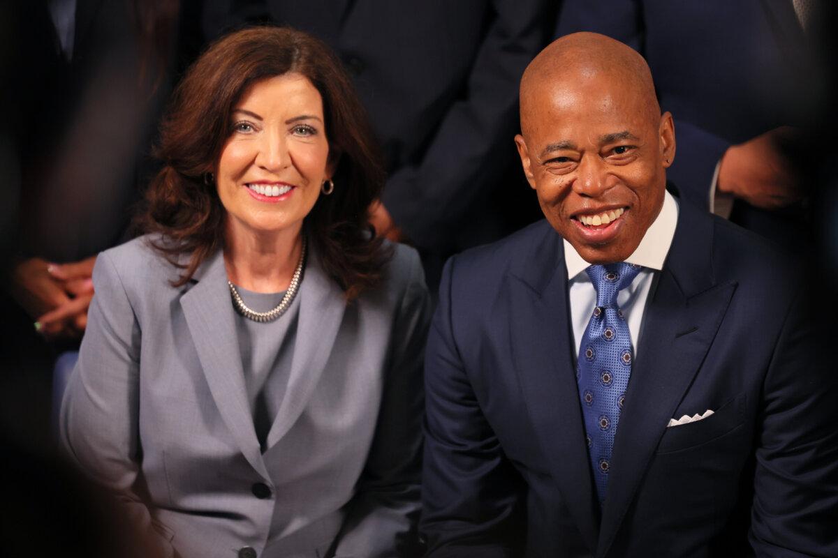 New York Gov. Kathy Hochul and Mayor Eric Adams laugh as they await the start of a press conference on violence prevention and public safety in New York City on July 31, 2023. (Michael M. Santiago/Getty Images)