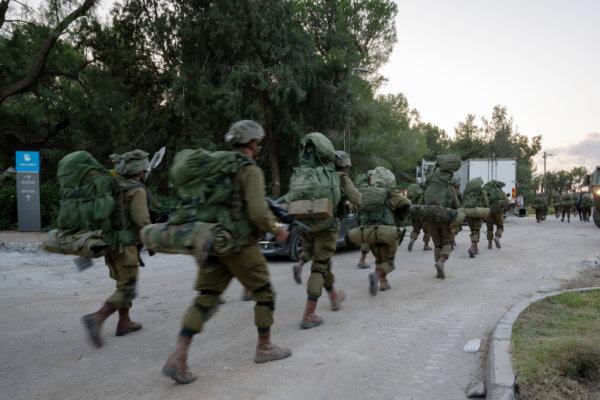 Israel Defense Forces soldiers walk through Kibbutz Be'eri where days earlier Hamas militants killed over a hundred civilians near the border with Gaza in Be'eri, Israel, on Oct. 11, 2023. (Alexi J. Rosenfeld/Getty Images)