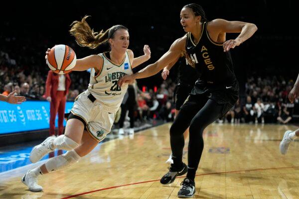 New York Liberty guard Sabrina Ionescu (20) drives against Las Vegas Aces center Kiah Stokes (41) during the first half in Game 2 of a WNBA basketball final playoff series in Las Vegas on Oct. 11, 2023. (John Locher/AP Photo)