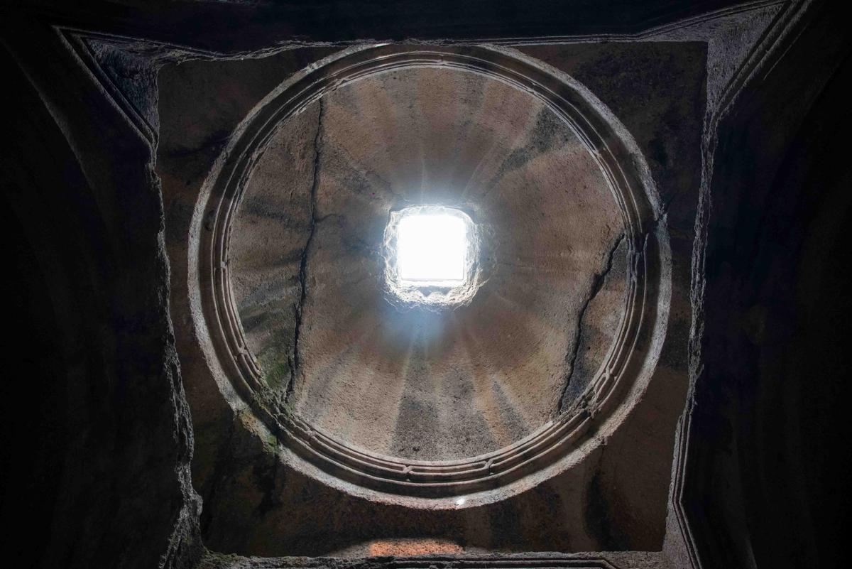 A portal in the Upper Jhamatun at Geghard allows natural light to illuminate the fully excavated interior within the mountain. (Davit Mohrabyan/Shutterstock)