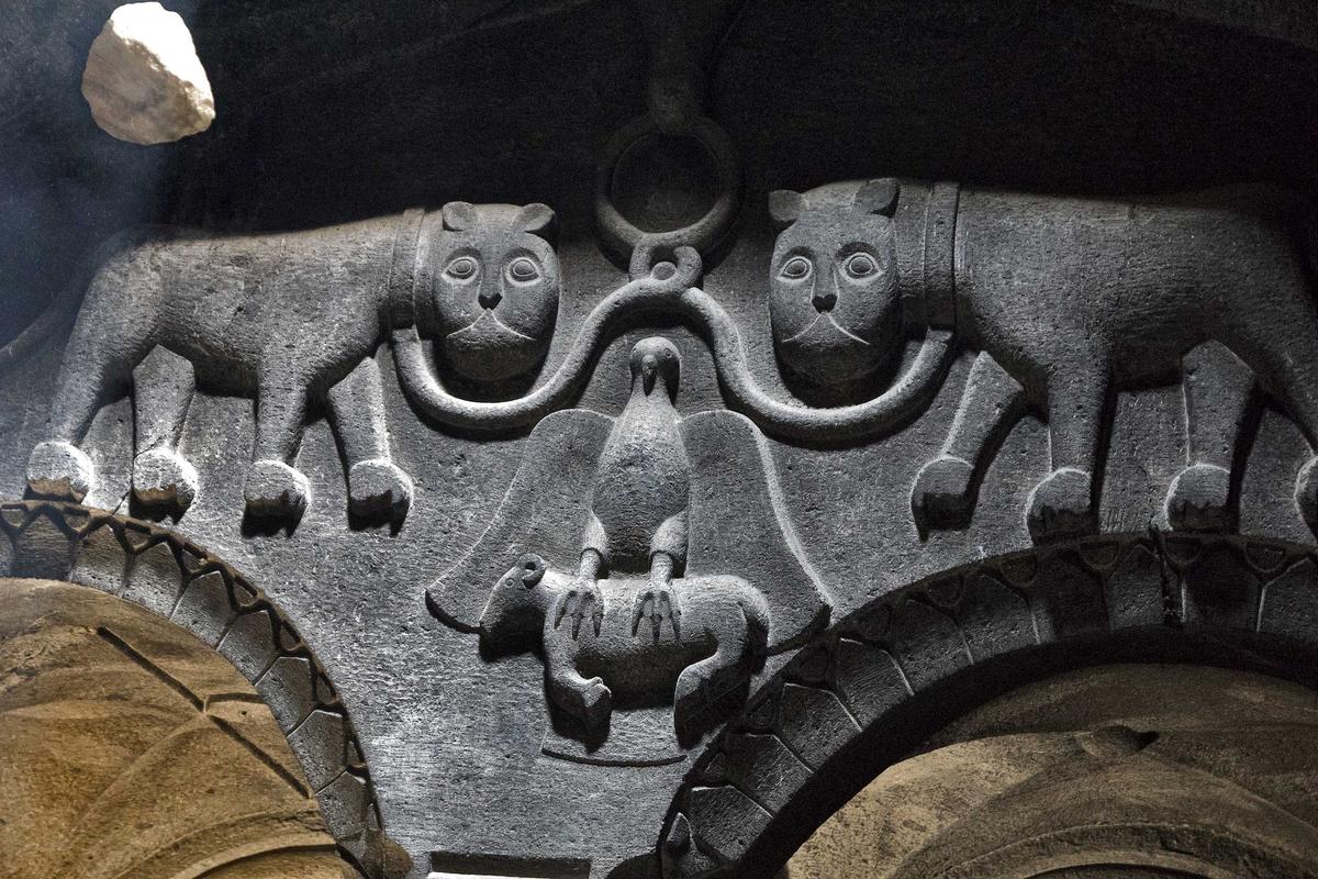 A carving, thought to be the 13th-century church owner's coat-of-arms, depicts lions in chains and an eagle clasping a lamb. (Odessa25/Shutterstock)