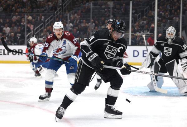 Anze Kopitar (11) of the Los Angeles Kings collects a rebound in front of Nathan MacKinnon (29) of the Colorado Avalanche during the first period in the Los Angeles Kings season opening game in Los Angeles on Oct. 11, 2023. (Harry How/Getty Images)