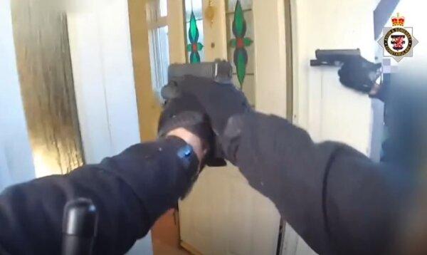 A screenshot of a video showing firearms officers pointing into the house of Reed Wischhusen in Wick St. Lawrence, Somerset on Nov. 28, 2022. (Avon and Somerset Police)