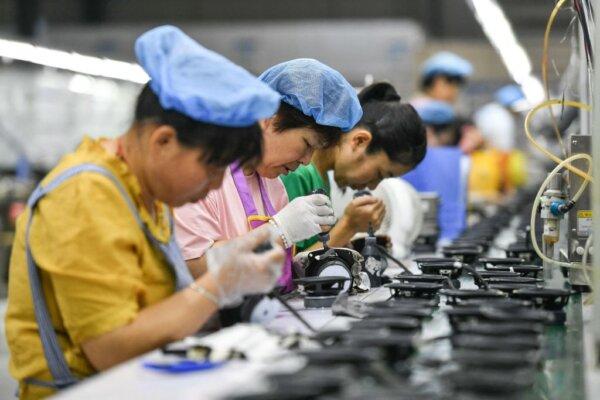  Employees work on an assembly line producing speakers at a factory in Fuyang, in China's eastern Anhui Province, on June 30, 2023. (AFP via Getty Images)
